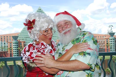 Santa and Mrs. Claus on a Balcony with Walt Disney World Dolphin Resort in the Background