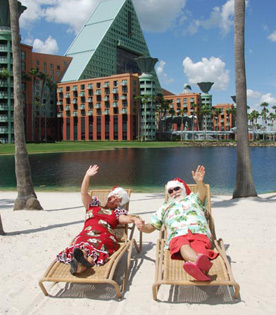 Santa and Mrs. Claus Waving to Guests from Their Beach Chairs